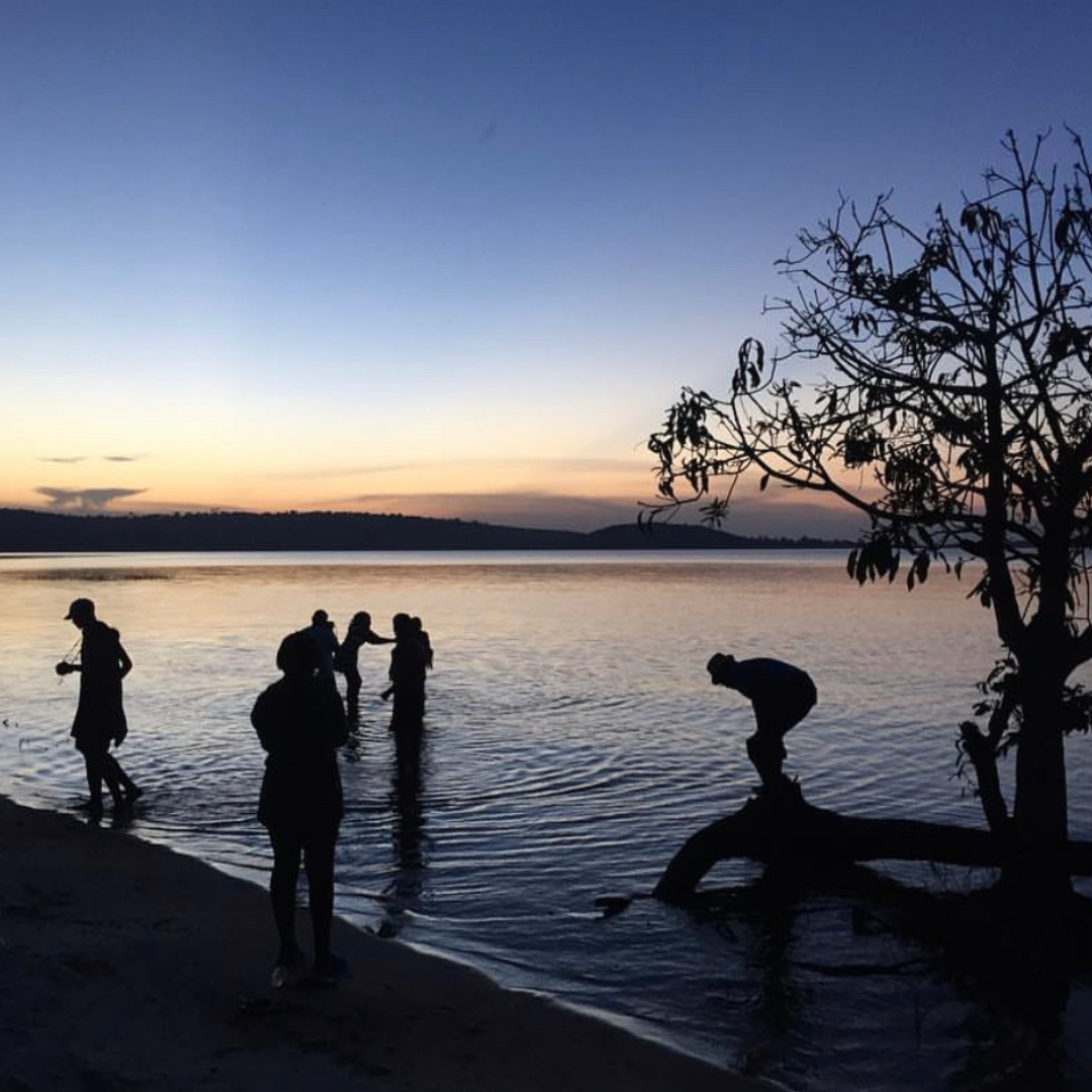 Guests at sunset on the Ssese Islands shoreline, Lake Victoria
